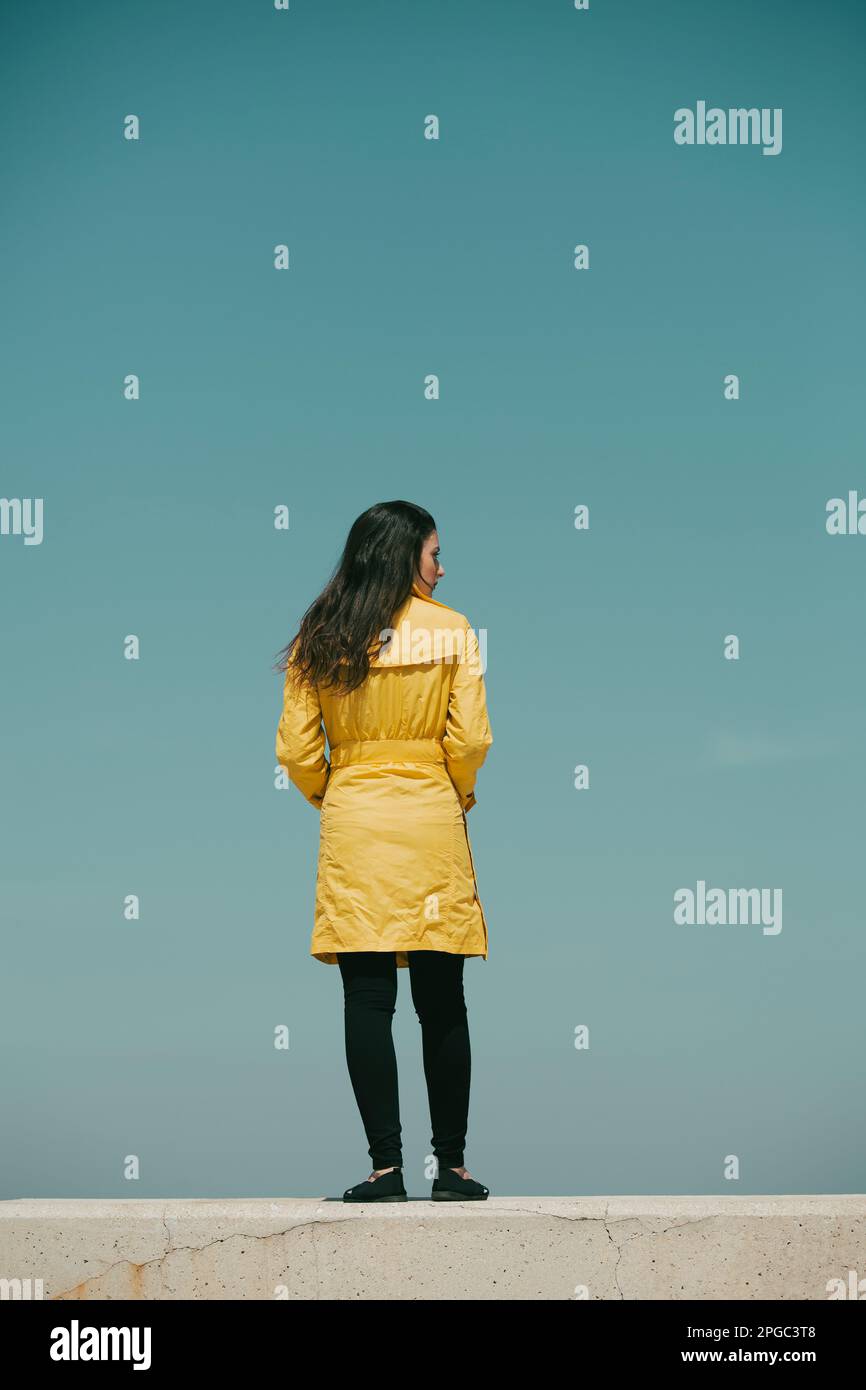 Woman in yellow coat hi-res stock photography and images - Alamy