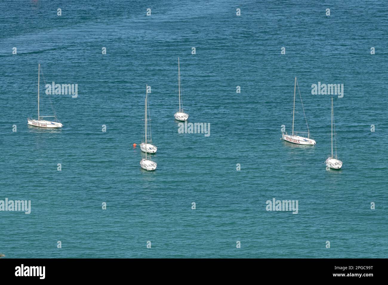 Aerial view of a white yacht with a sail. Ship in the blue sea Corniche beach Doha Stock Photo