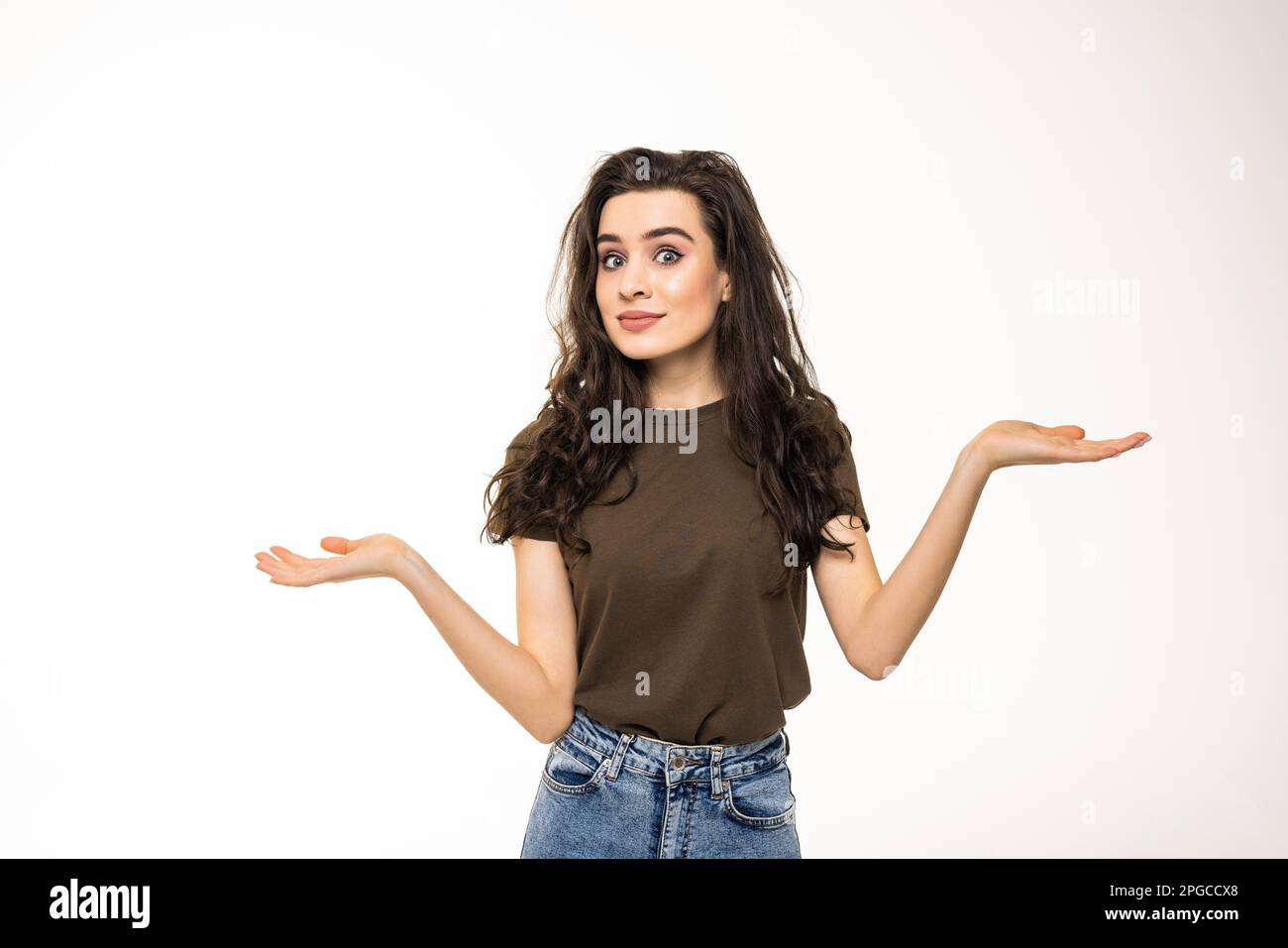 Beautiful woman making a scale with her arms wide open, isolated in a white background Stock Photo