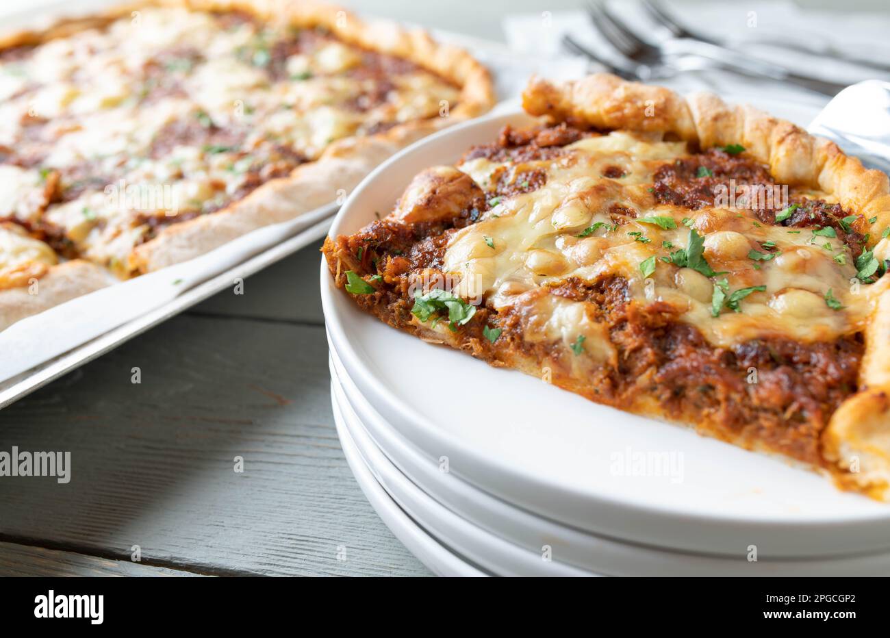 Pizza with stewed meat and melted cheese topping. Delicious leftover meal Stock Photo
