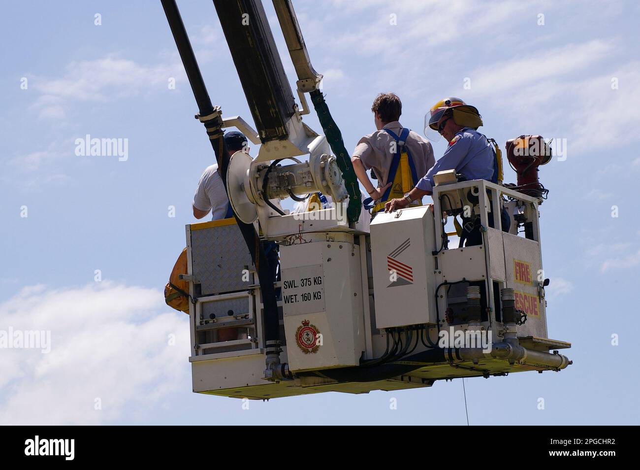 Fire and Rescue demonstration at Tamborine Mountain Show 2005. Overhead Rescue platform on extending fire ladder. Visitors and firefighters. Australia Stock Photo