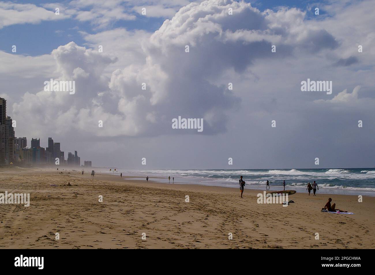 Late afternnoon on wide Surfers Paradise beach. Cool, cloudy weather, almost deserted for miles. Rough sea, incoming storm. Gold Coast, Australia. Stock Photo