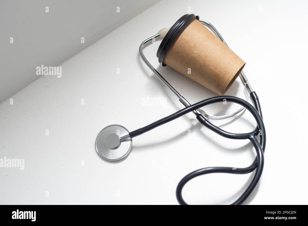 stethoscope and takeaway coffee on a white background. Stock Photo