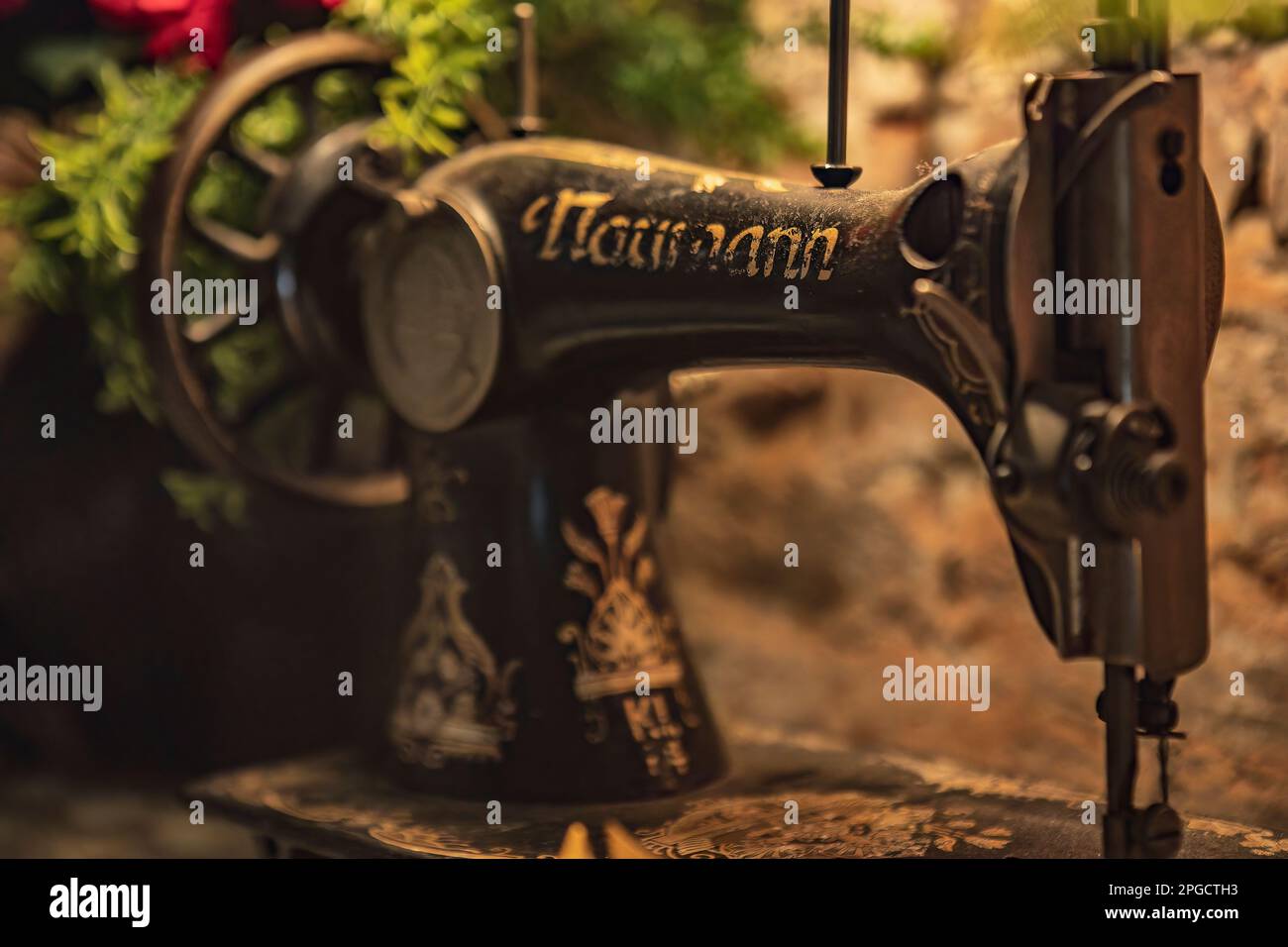 A vintage sewing machine, a testament to the Industrial Revolution, displaying intricate details and mechanical design Stock Photo