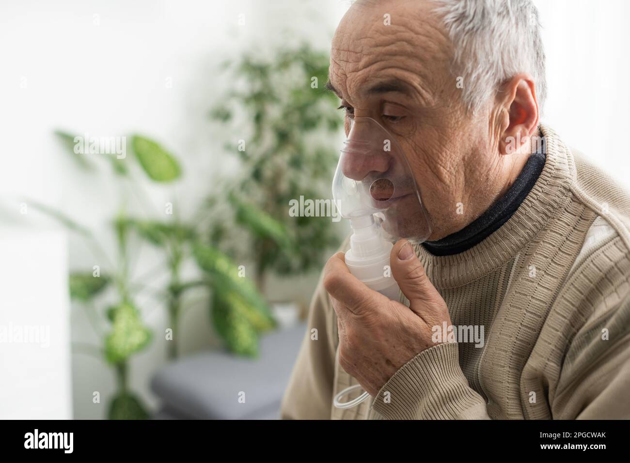 Elderly Senior Man nursing care wear oxygen inhaler device for helping