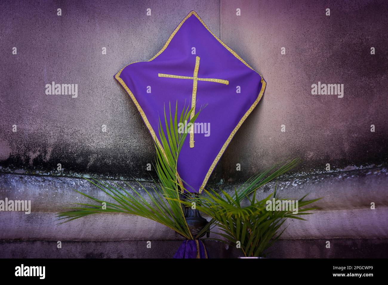 Holy Week. Cross covered with purple fabric in the period of lent