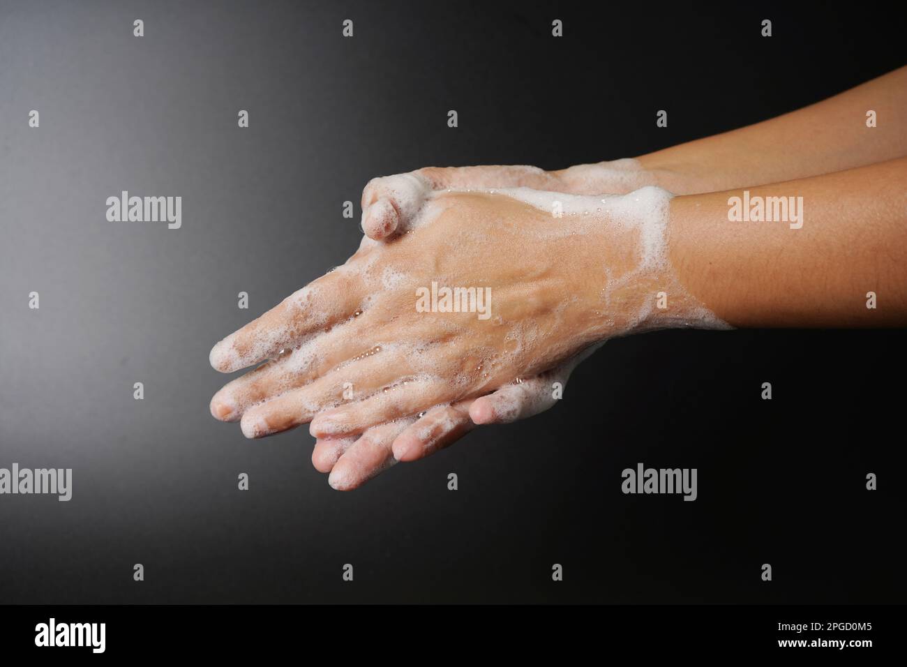 Washing hand on dark background Stock Photo