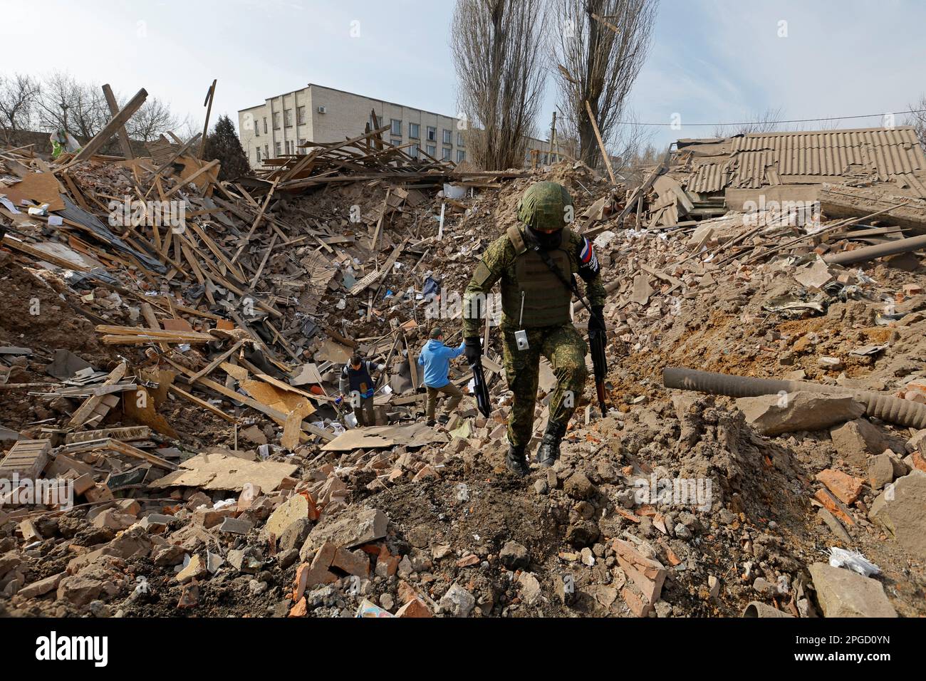 A member of the Russian Investigative Committee walks out of a shell crater in the ruins of the water supply station building destroyed by recent shelling in the course of Russia-Ukraine conflict in Donetsk, Russian-controlled Ukraine, March 22, 2023. REUTERS/Alexander Ermochenko Stock Photo
