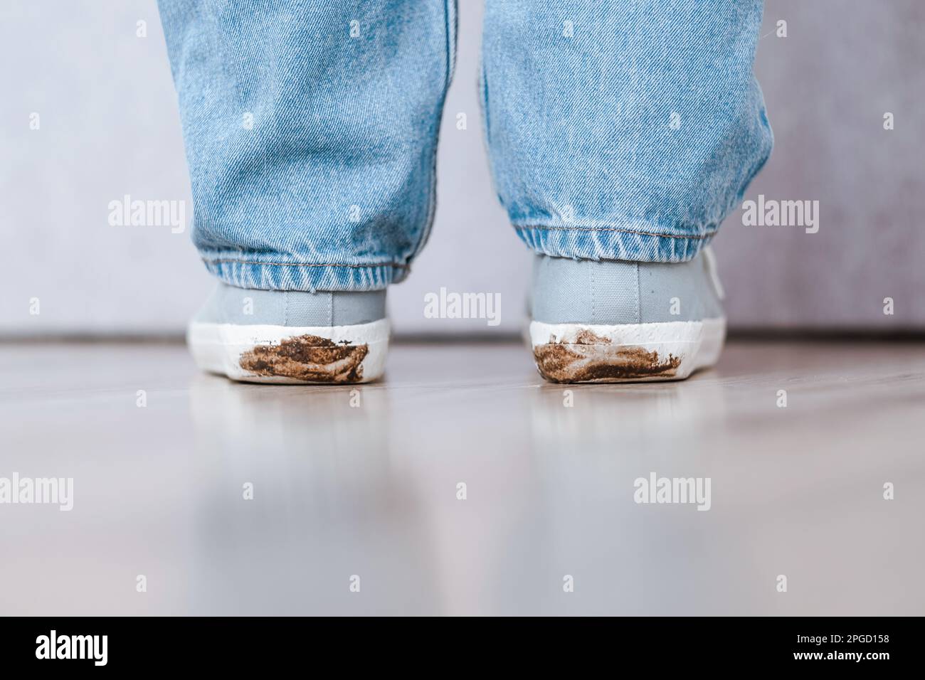 Muddy foodprint on the heels of shoes. Mud footprint indoors on floor Stock Photo