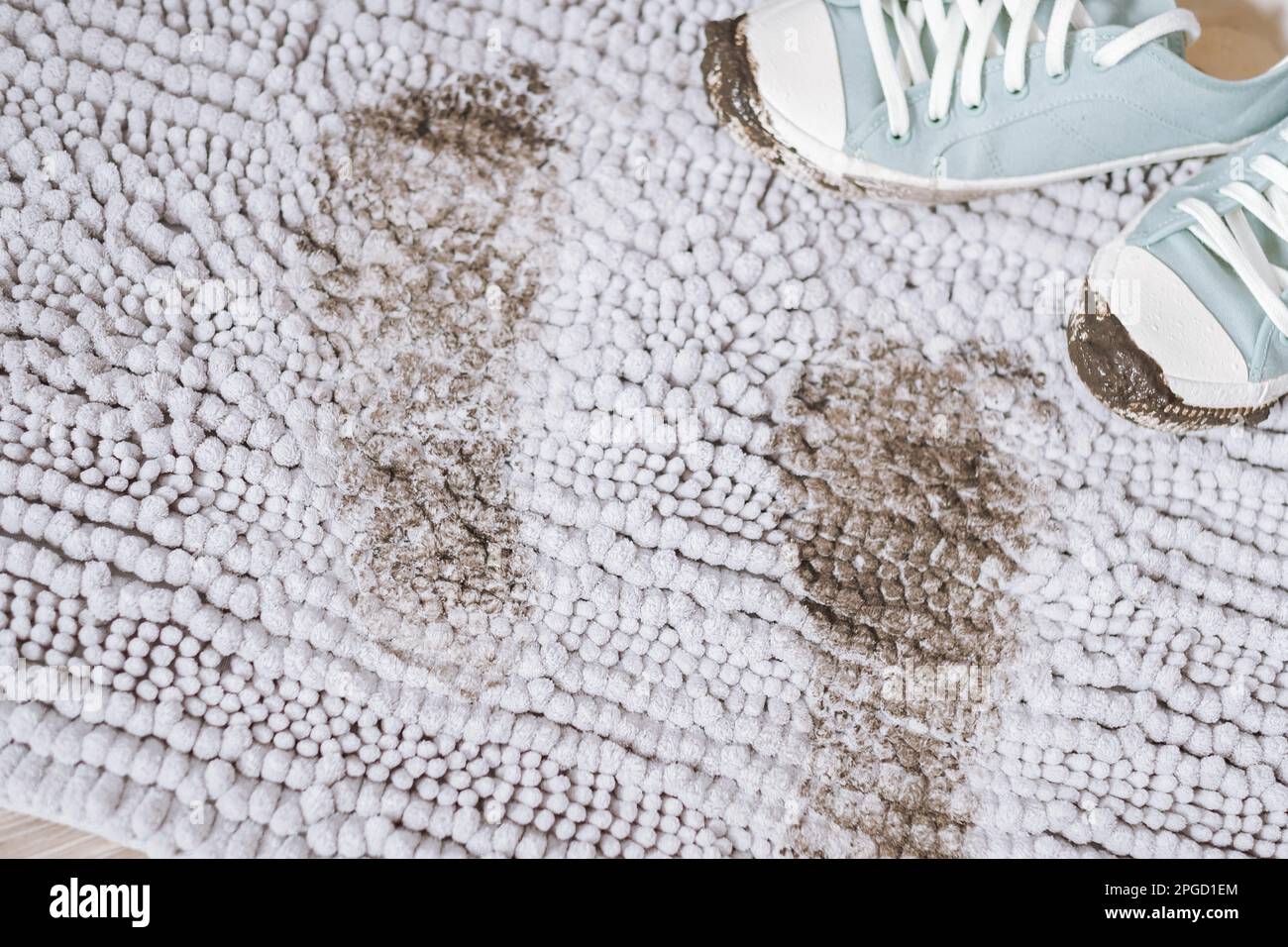 Trail of muddy footprint on gray carpet. Daily life dirty stain Stock