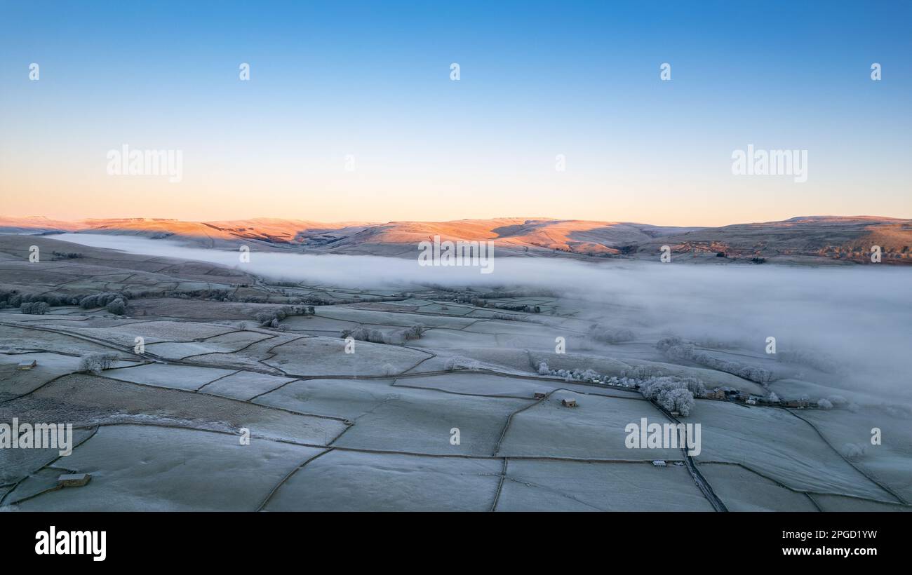 Frosty winter morning over Hawes in Upper Wensleydale, with a cloud inversion, covering some of the dale in mist. Yorkshire Dales National Park, UK. Stock Photo