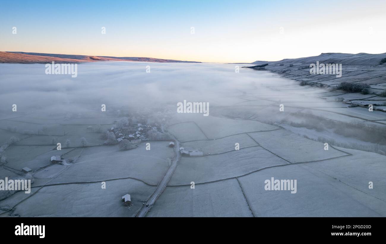 Frosty winter morning over Hawes in Upper Wensleydale, with a cloud inversion, covering some of the dale in mist. Yorkshire Dales National Park, UK. Stock Photo