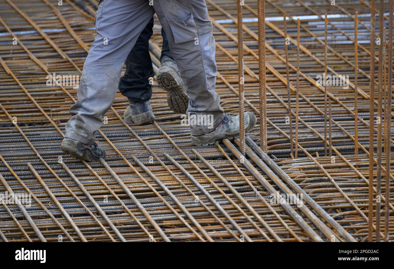 Dresden, Germany. 22nd Mar, 2023. A construction worker walks along a reinforced concrete ceiling at the building site of the extension to the headquarters of Carl Zeiss Digital Innovation GmbH at Fritz-Foerster-Platz. The technology company is further expanding its Dresden site. After completion, more than 400 jobs are to be created. Credit: Robert Michael/dpa/Alamy Live News Stock Photo