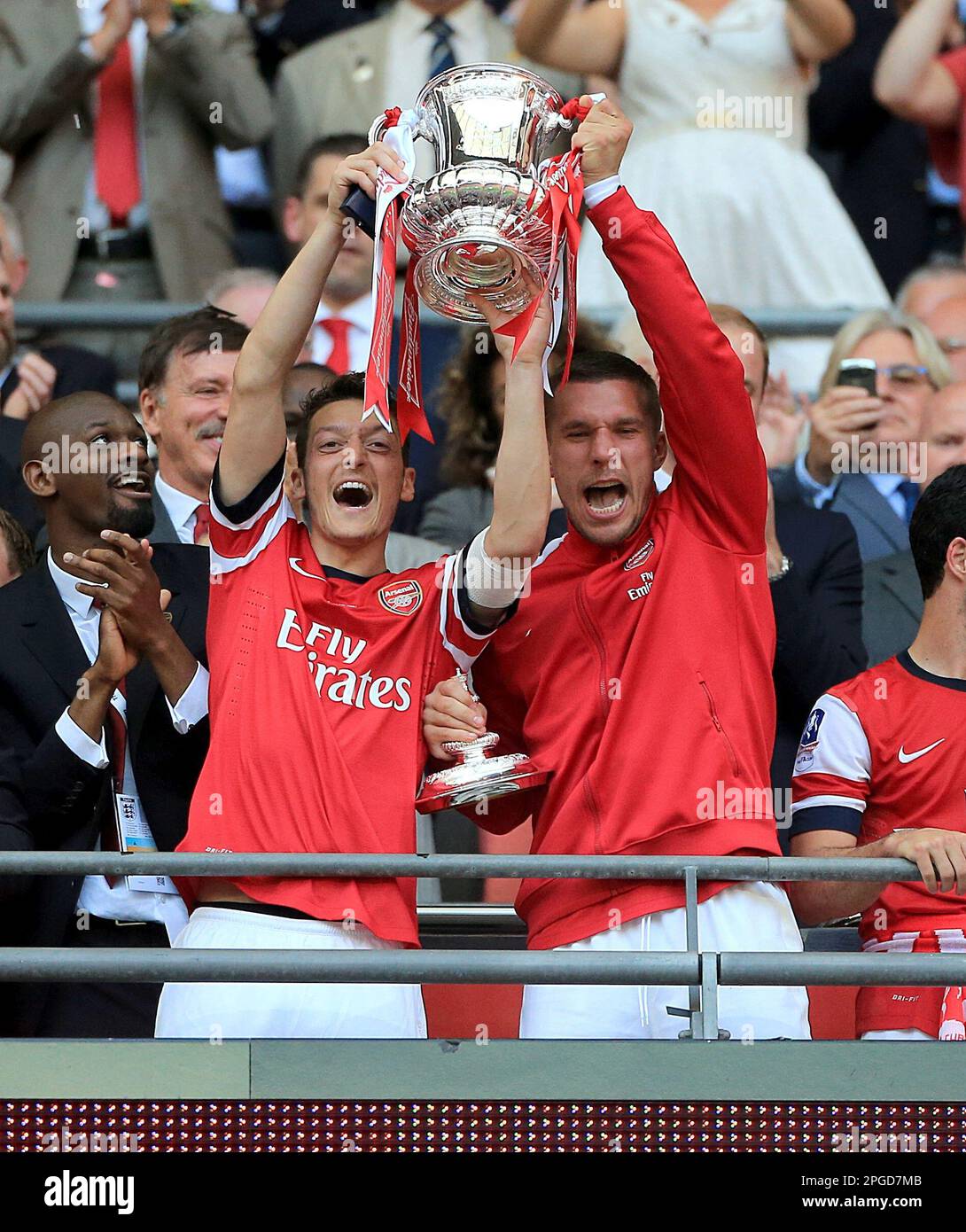 File photo dated 17-05-2014 of Arsenal's Mesut Ozil (left) and Lukas Podolski celebrate with the FA Cup trophy. Former Arsenal and Real Madrid midfielder Mesut Ozil has announced his retirement at the age of 34. Issue date: Wednesday March 22, 2023. Stock Photo