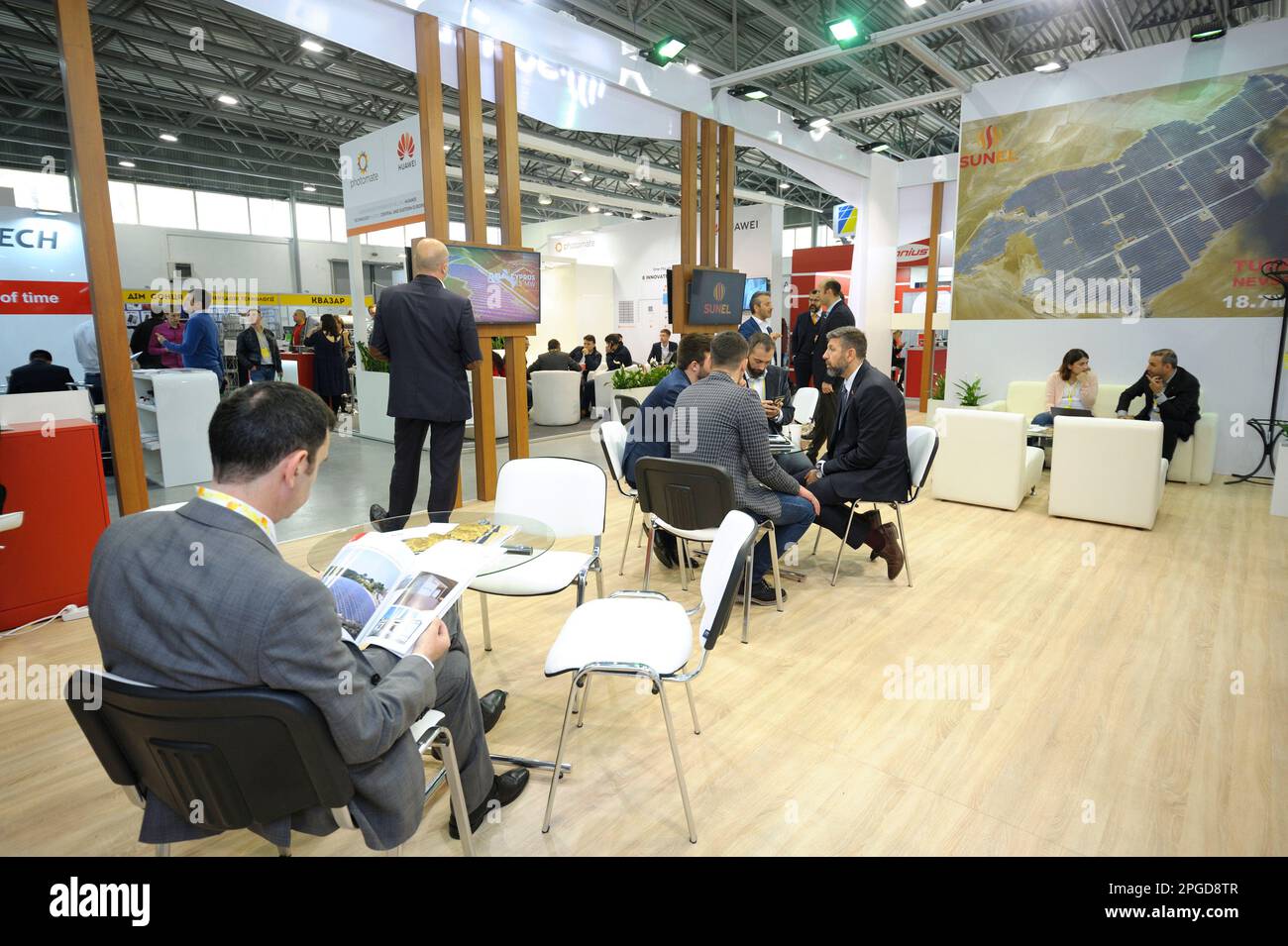 Engaging in dialogue. Businessmen sitting at the table at the stand
