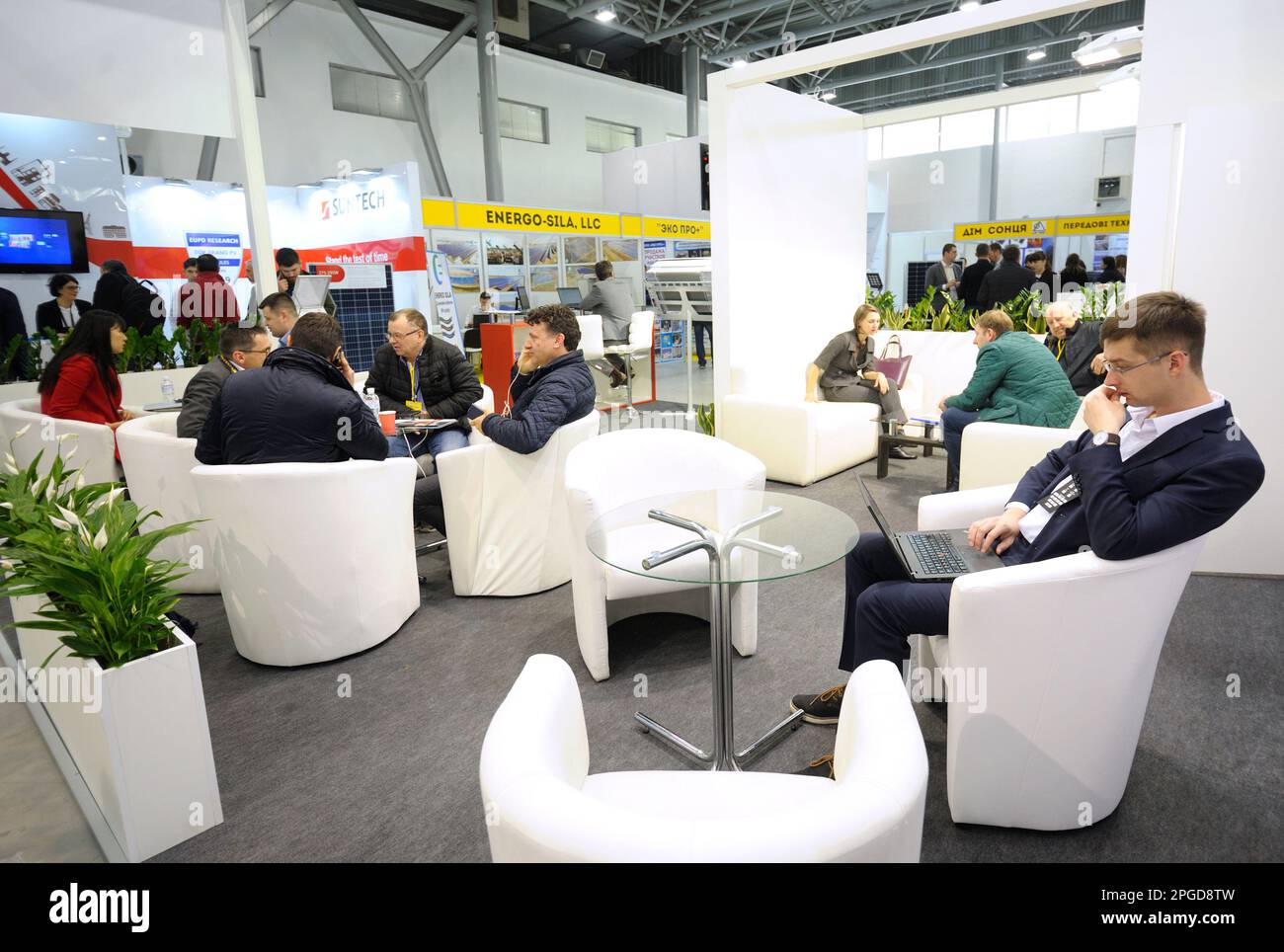 Engaging in dialogue. Businessmen sitting at the table at the stand