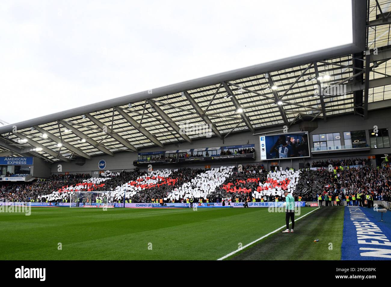 Grimsby Town Football Club fans hold up cards forming the three fishes on the clubs badge - Brighton & Hove Albion v Grimsby Town, The Emirates FA Cup Quarter Final, Amex Stadium, Brighton, UK - 19th March 2023  Editorial Use Only - DataCo restrictions apply Stock Photo