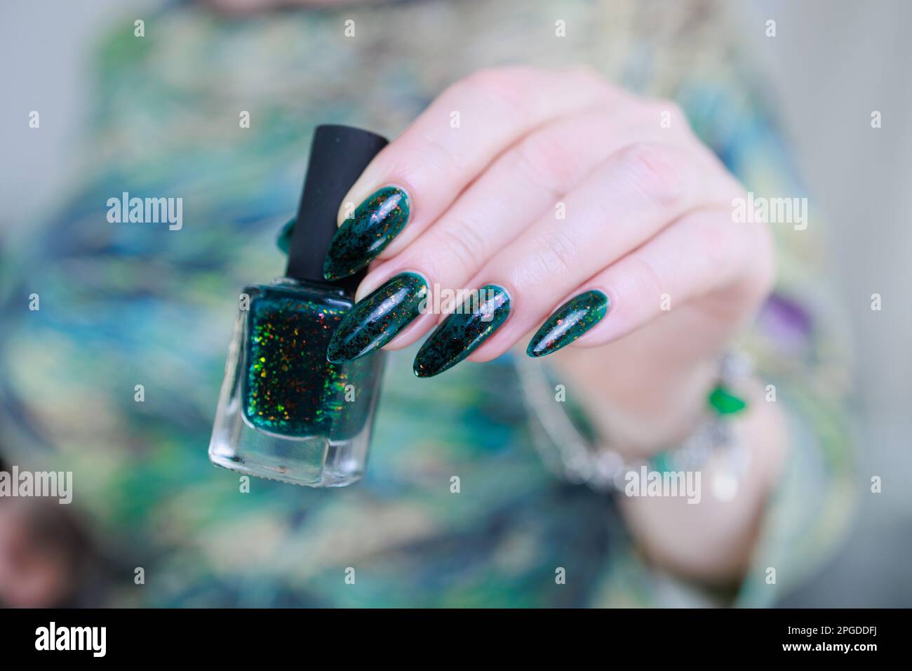 Woman s Hand With Long Nails And Dark Green Nail Polish Stock Photo Alamy