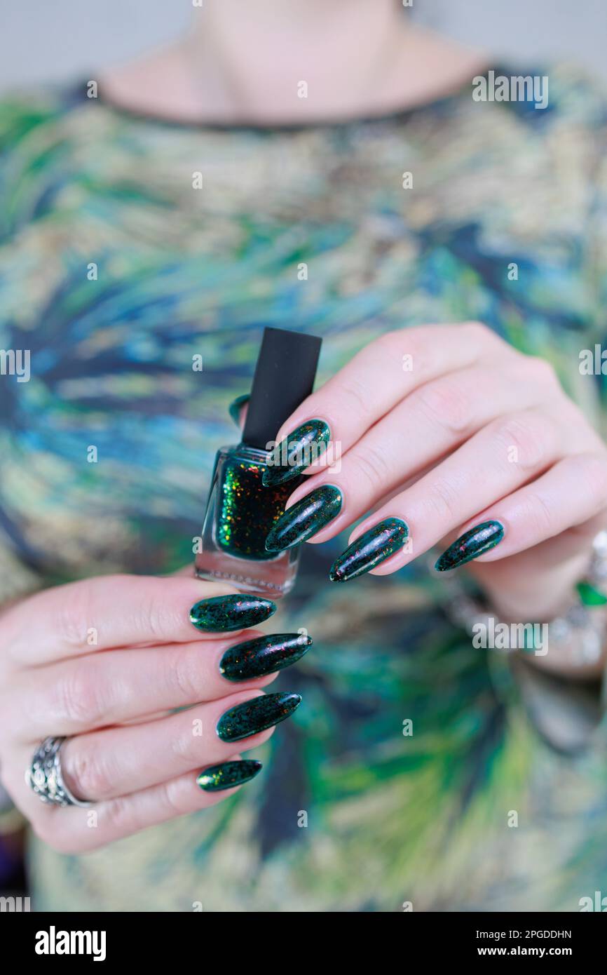 Woman s Hand With Long Nails And Dark Green Nail Polish Stock Photo Alamy