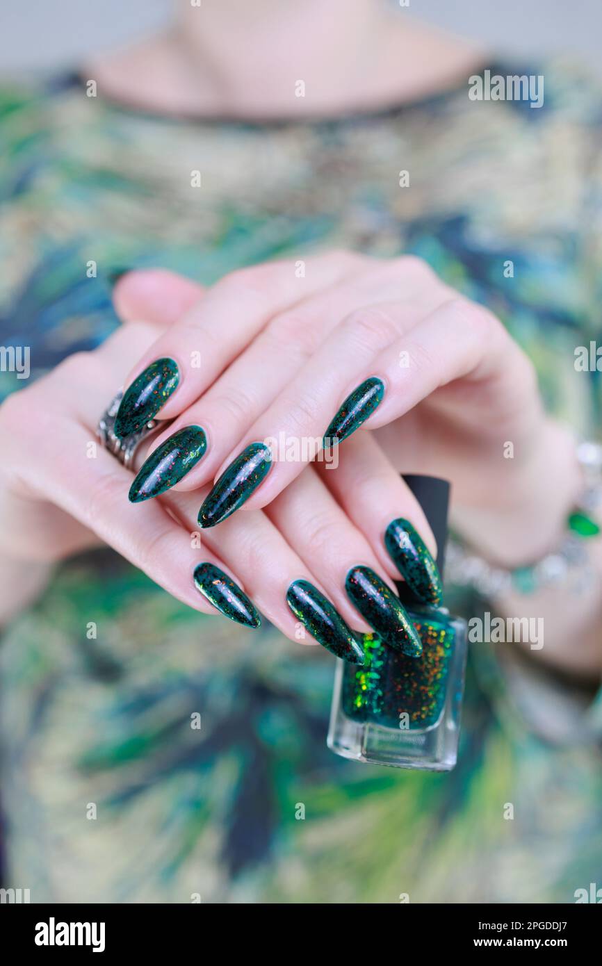 Woman s Hand With Long Nails And Dark Green Nail Polish Stock Photo Alamy