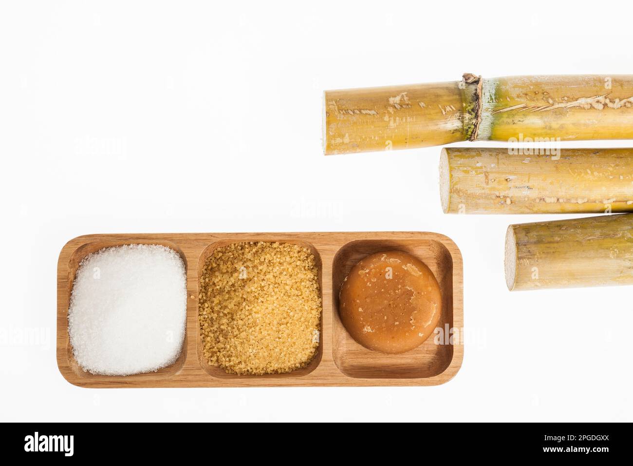 white sugar, brown sugar and sugar cane panela on white background