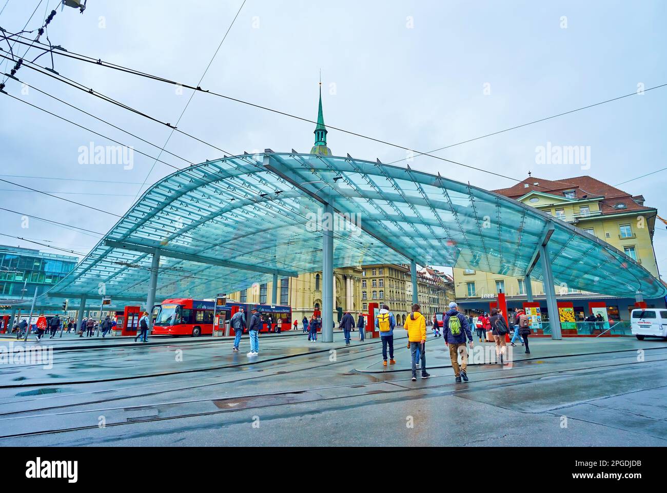 BERN, SWITZERLAND - MARCH 31, 2022: Public tram and trolley station with modern glass canopy on Bubenbergplatz, on March 31 in Bern, Switzerland Stock Photo