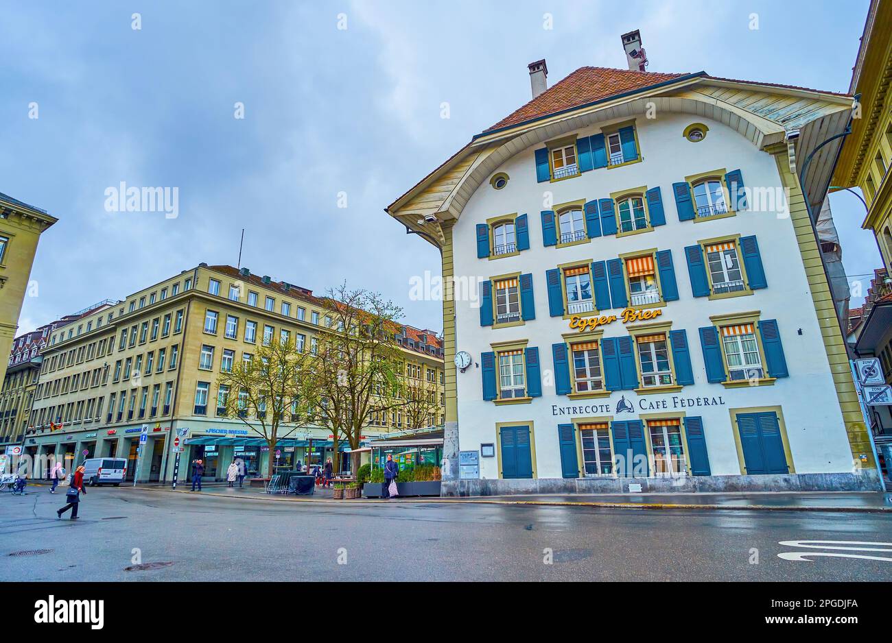 BERN, SWITZERLAND - MARCH 31, 2022: Bundesplatz square with medieval mansion with blue window shutters, on March 31 in Bern, Switzerland Stock Photo