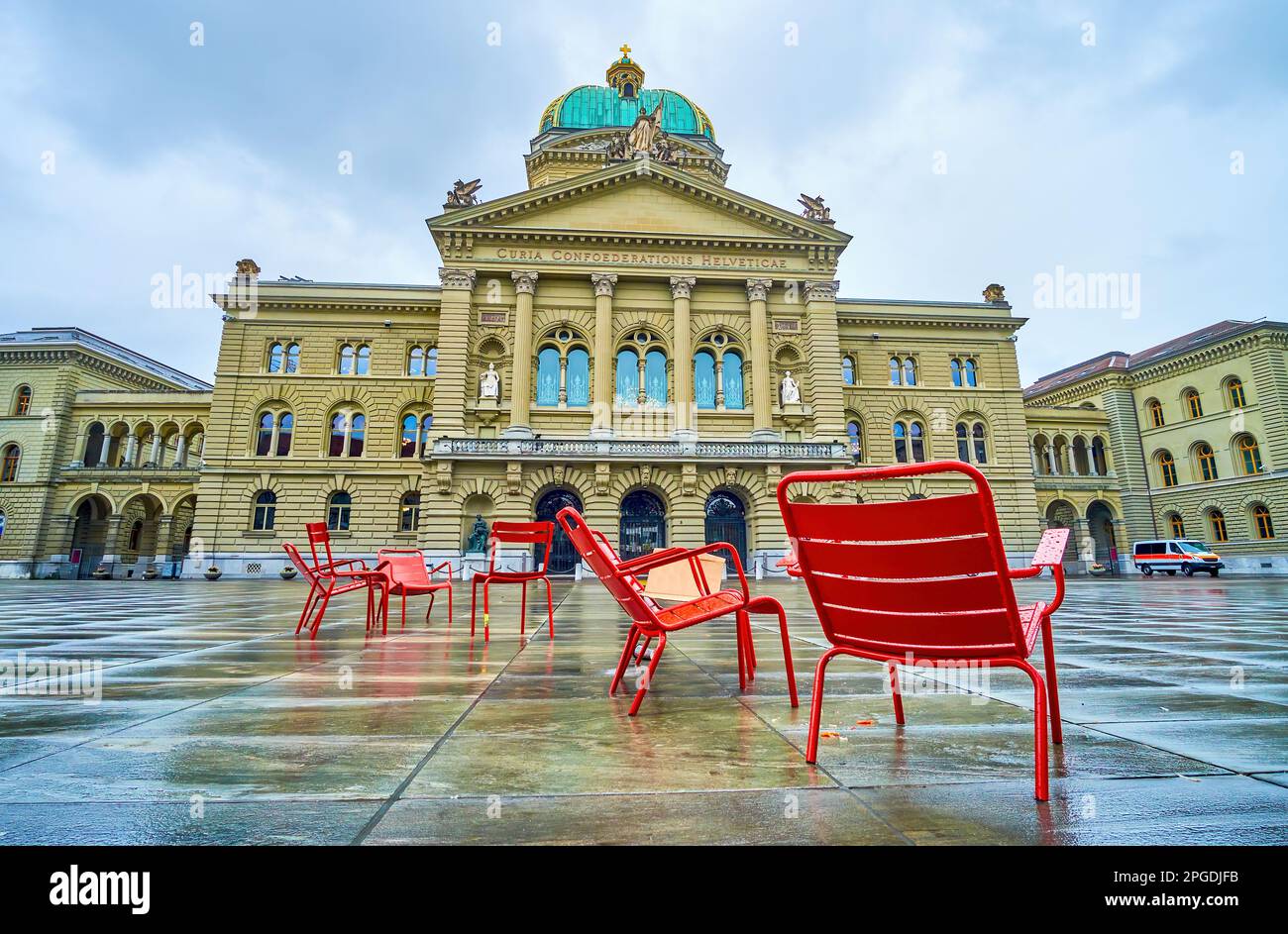 The red chairs on Bundeshaus square at Bundeshaus (Federal Palace) building in Bern, Switzerland Stock Photo
