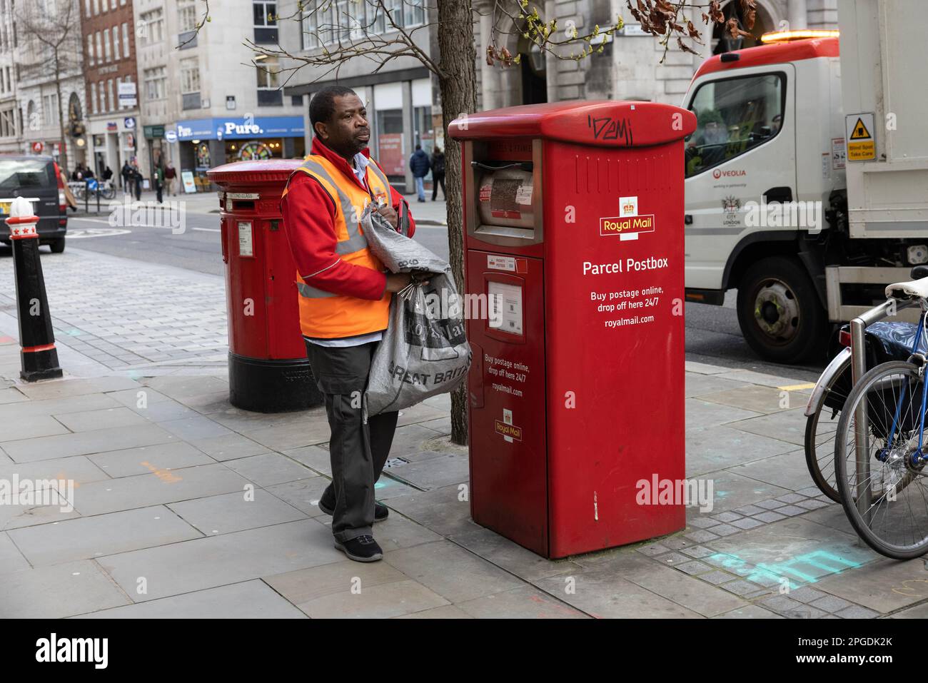 Royal Mail Postal Worker, collecting the daily post on Cheapside in the City of London, England