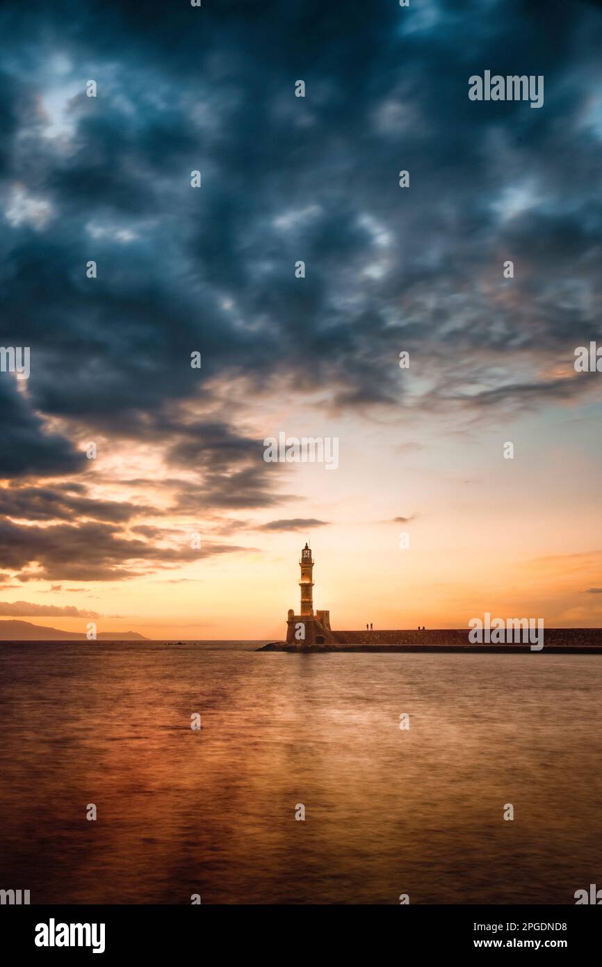 A lighthouse signals the entrance to the old Venetian harbor in Chania, Crete. Stock Photo
