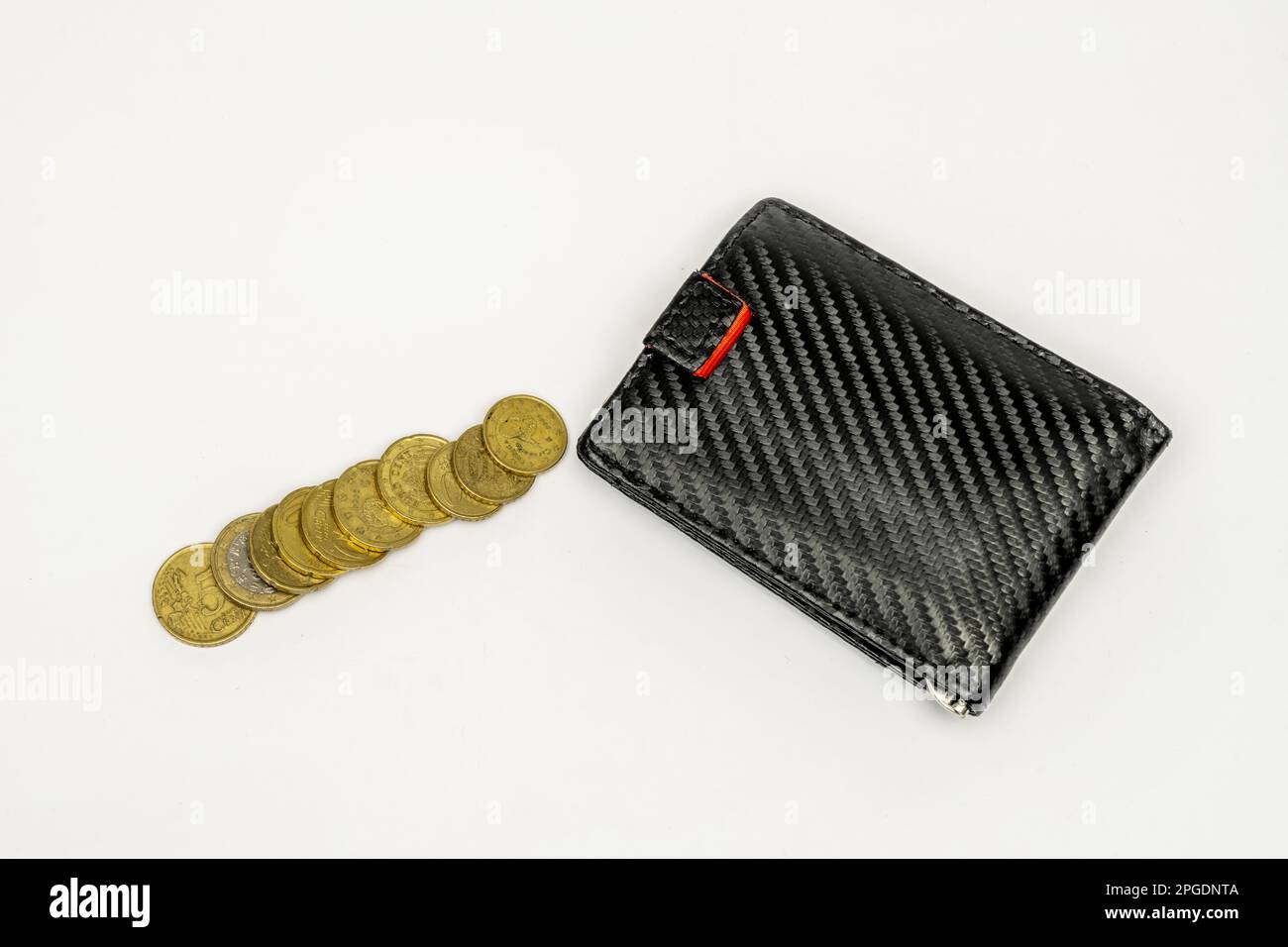 Carbon fiber men's wallet and a few coins commonly used in Europe Stock Photo