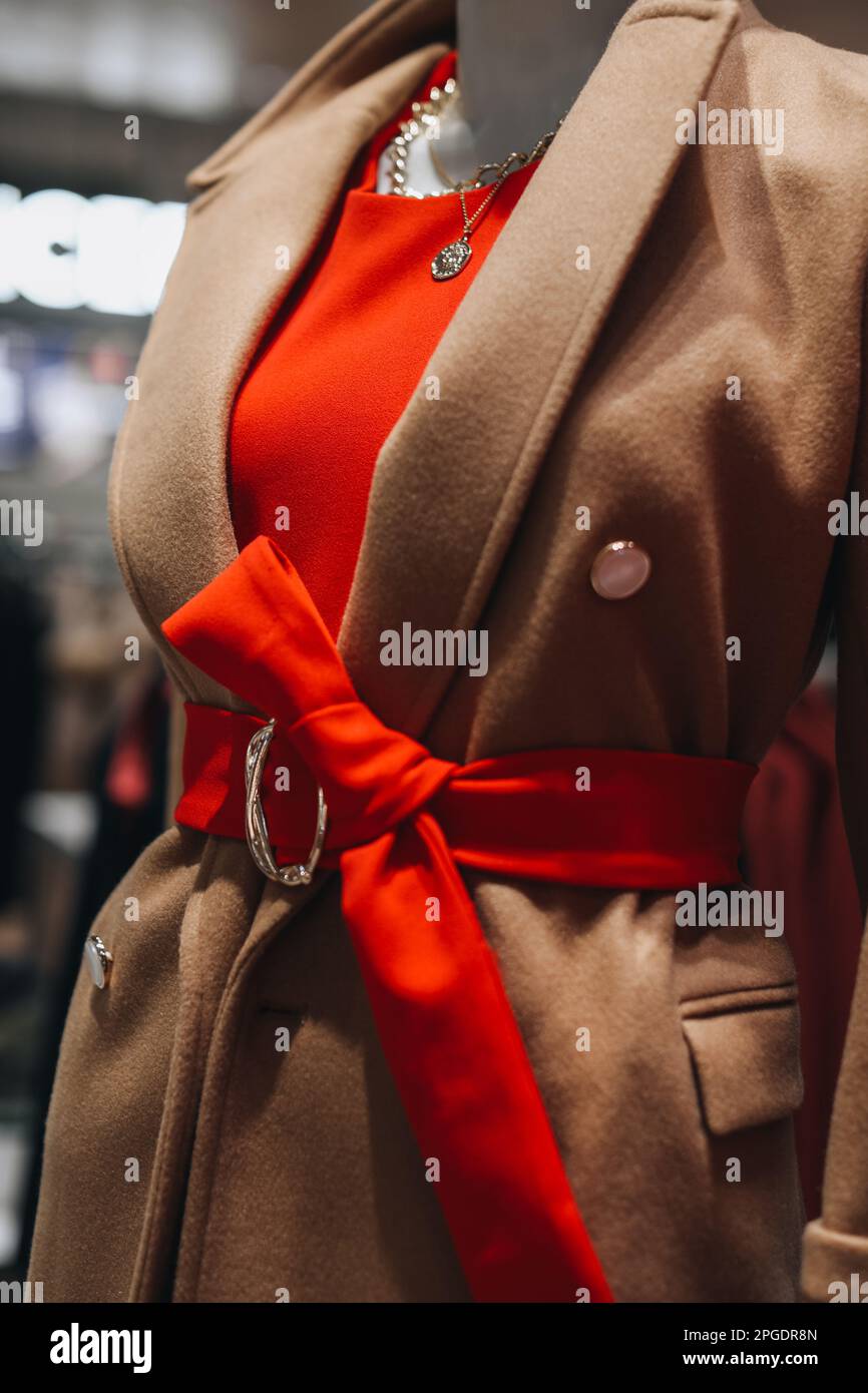 Fashion details of a brown coat with a red belt Stock Photo