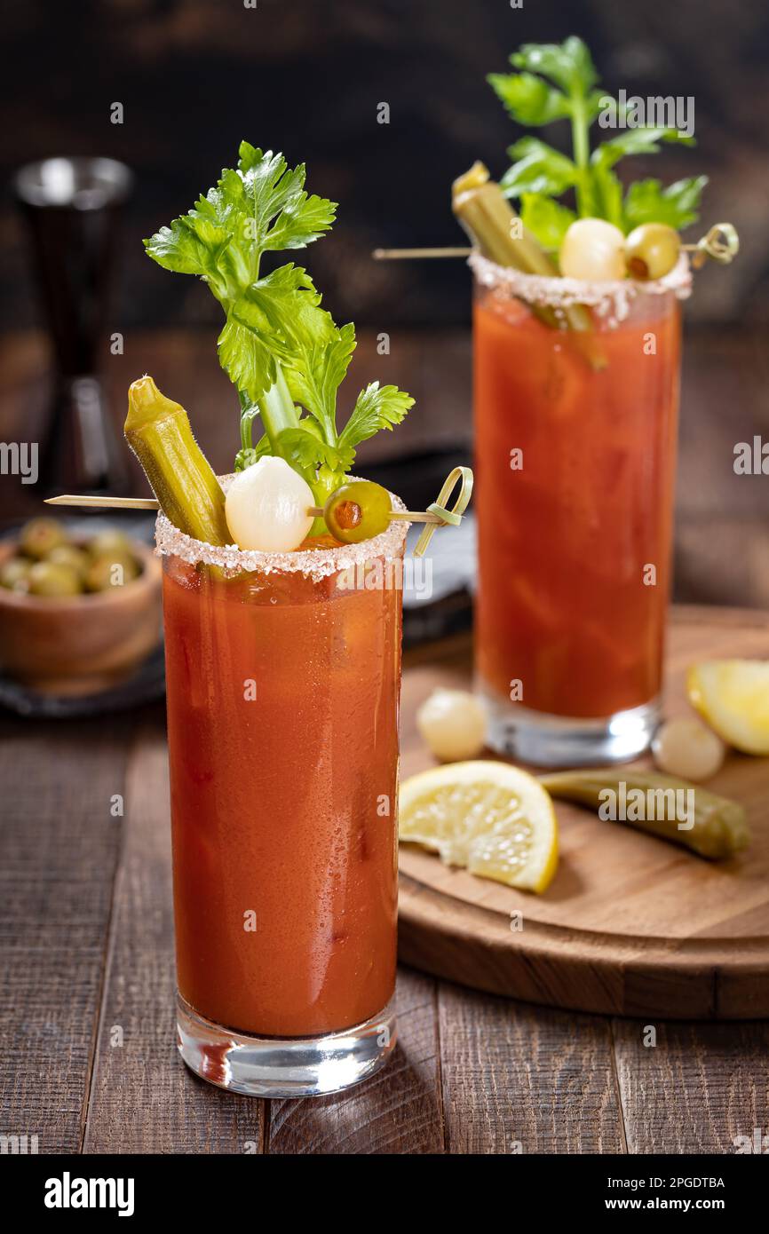 Bloody mary cocktail garnished with celery, okra, onion, olive and salt