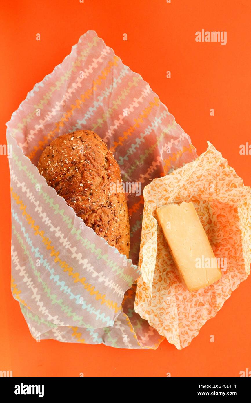 Overhead view of a loaf of brown bread and cheese in zero waste plastic