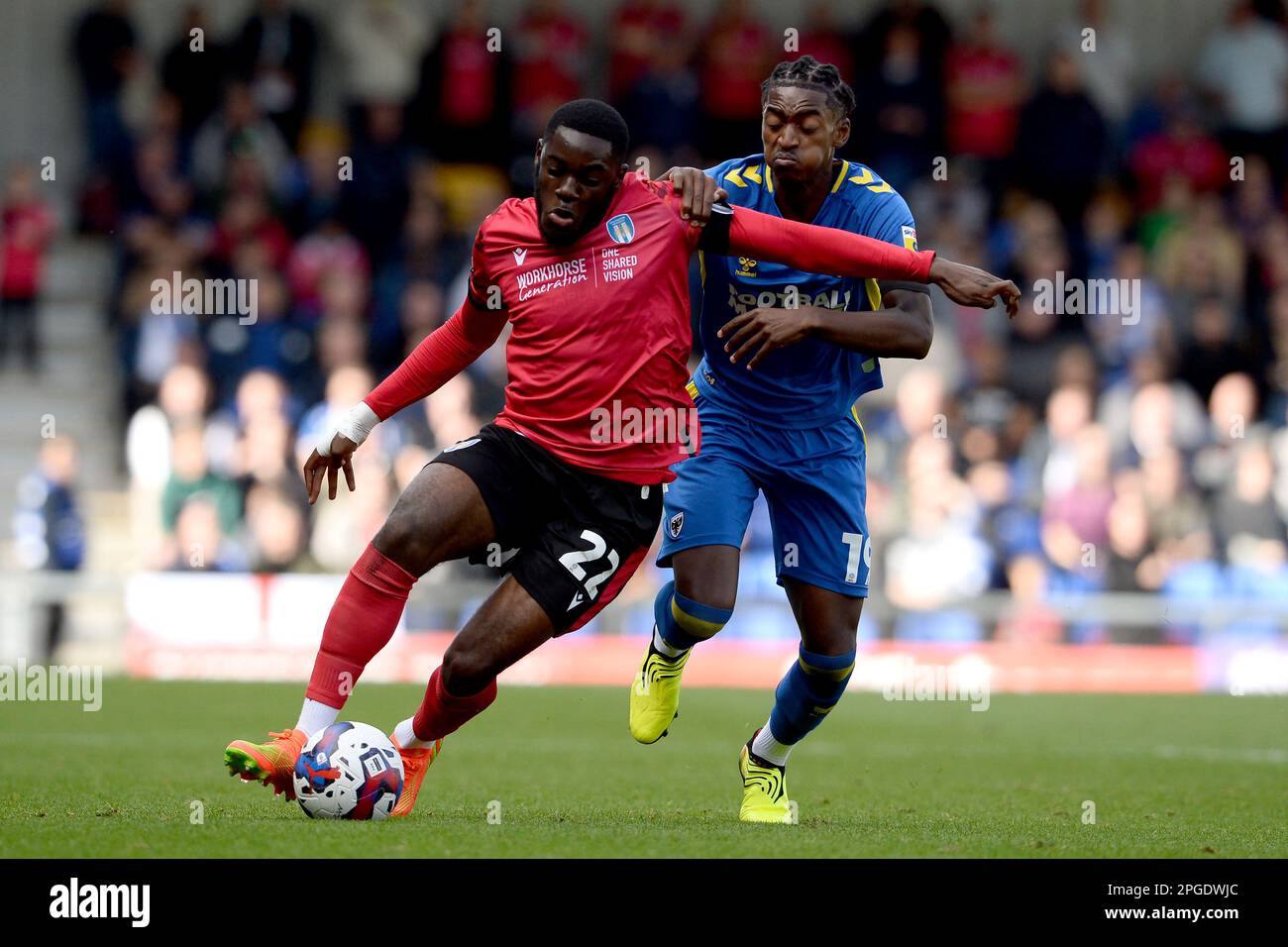 Junior Tchamadeu of Colchester United looks to get past Paris Maghoma of AFC Wimbledon - AFC Wimbledon v Colchester United, Sky Bet League Two, Cherry Red Records Stadium, Wimbledon, UK - 22nd October 2022  Editorial Use Only - DataCo restrictions apply Stock Photo