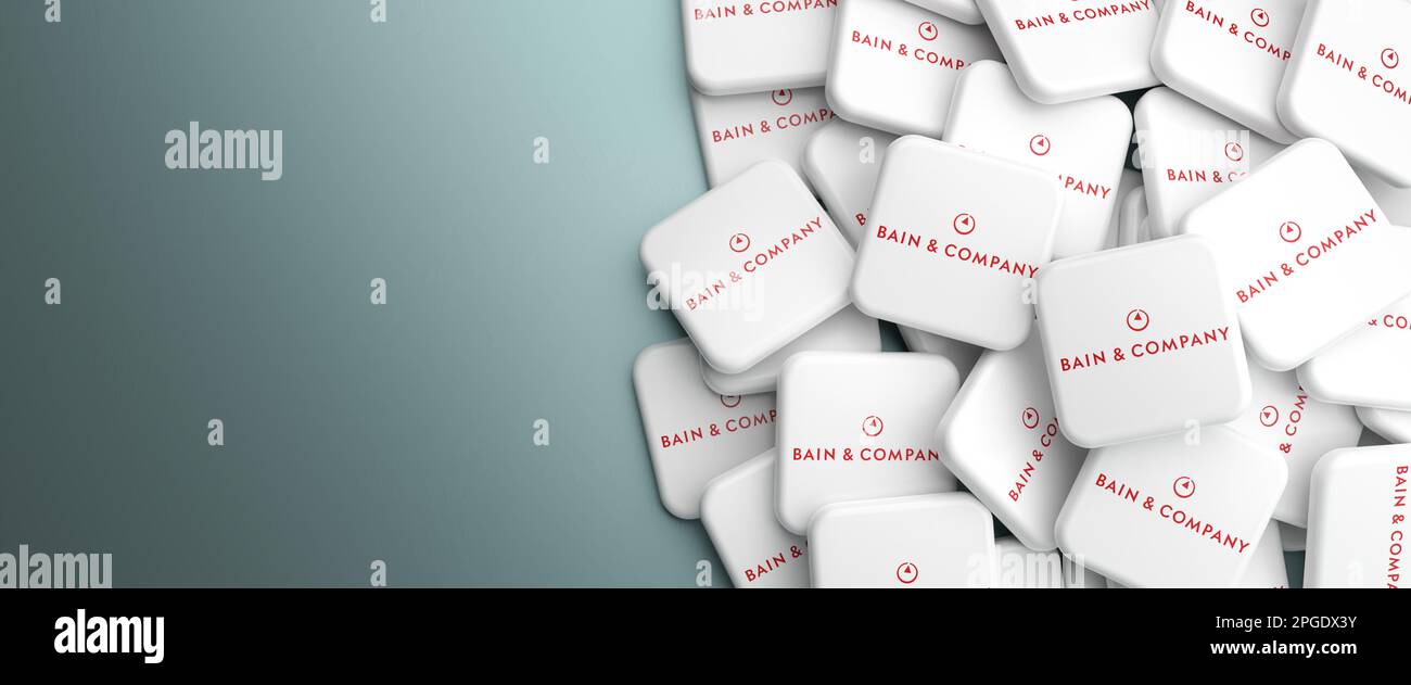Logos of the Big Three management consulting company Bain & Company on a heap on a table. Web banner format with copy space Stock Photo