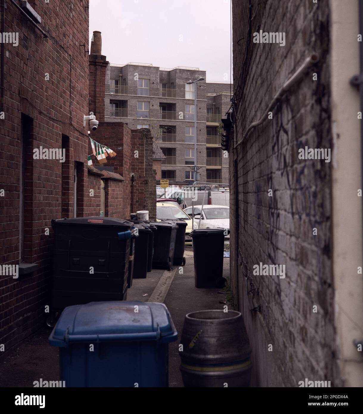 urban alleyway with bins and rubbish Stock Photo Alamy