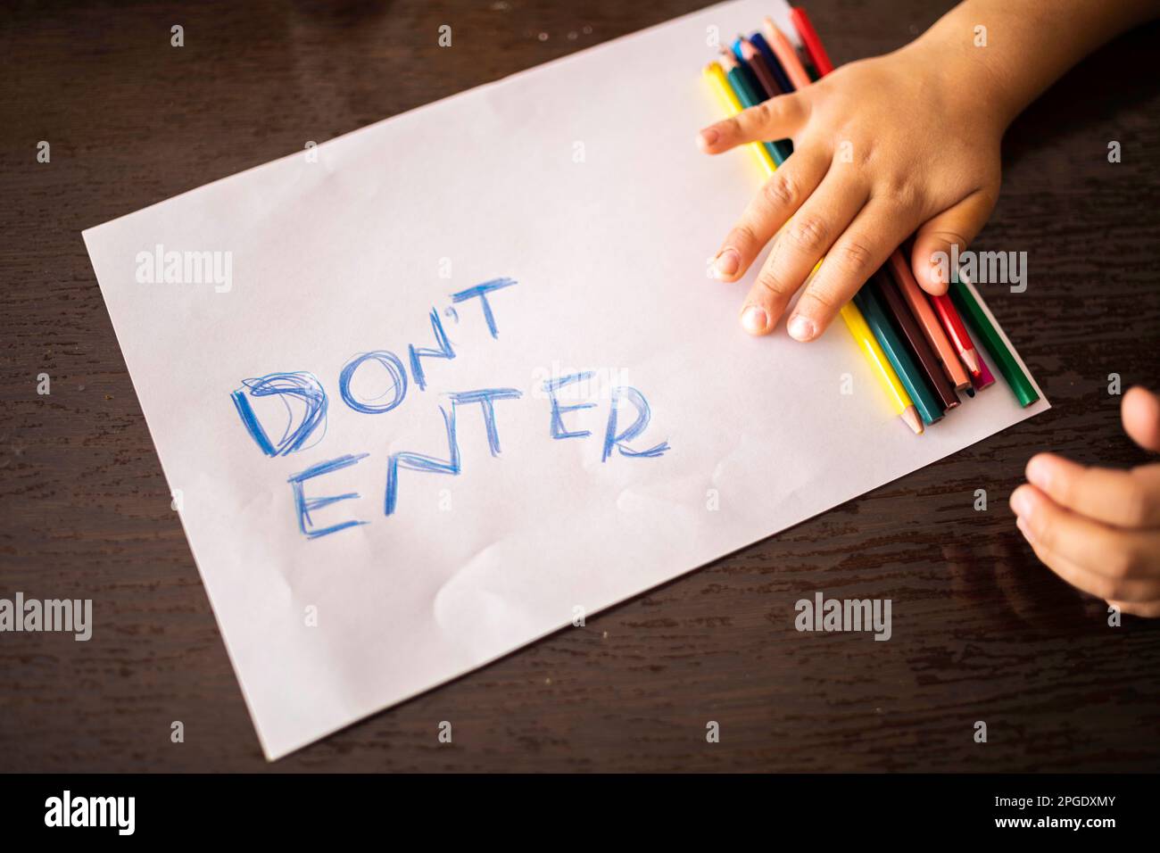 Children's Privacy and Personal Space concept. child's hands with pencils and paper wrote do not enter Stock Photo