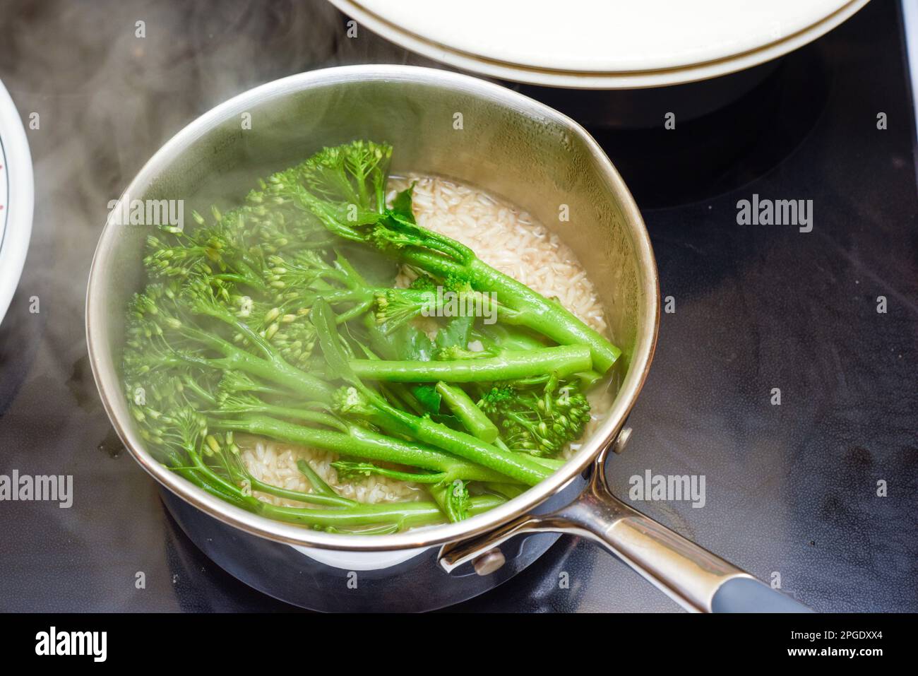 Steaming food in the pan broccoli and rice are cooking for a healthy