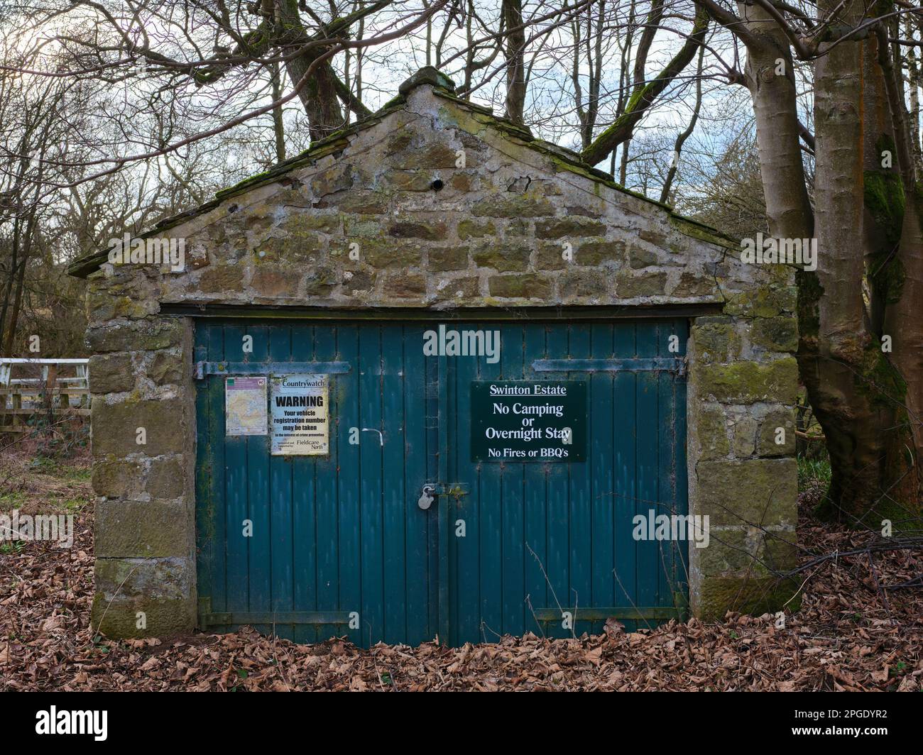 Blue, wooden double doors carry information notices for the Swinton