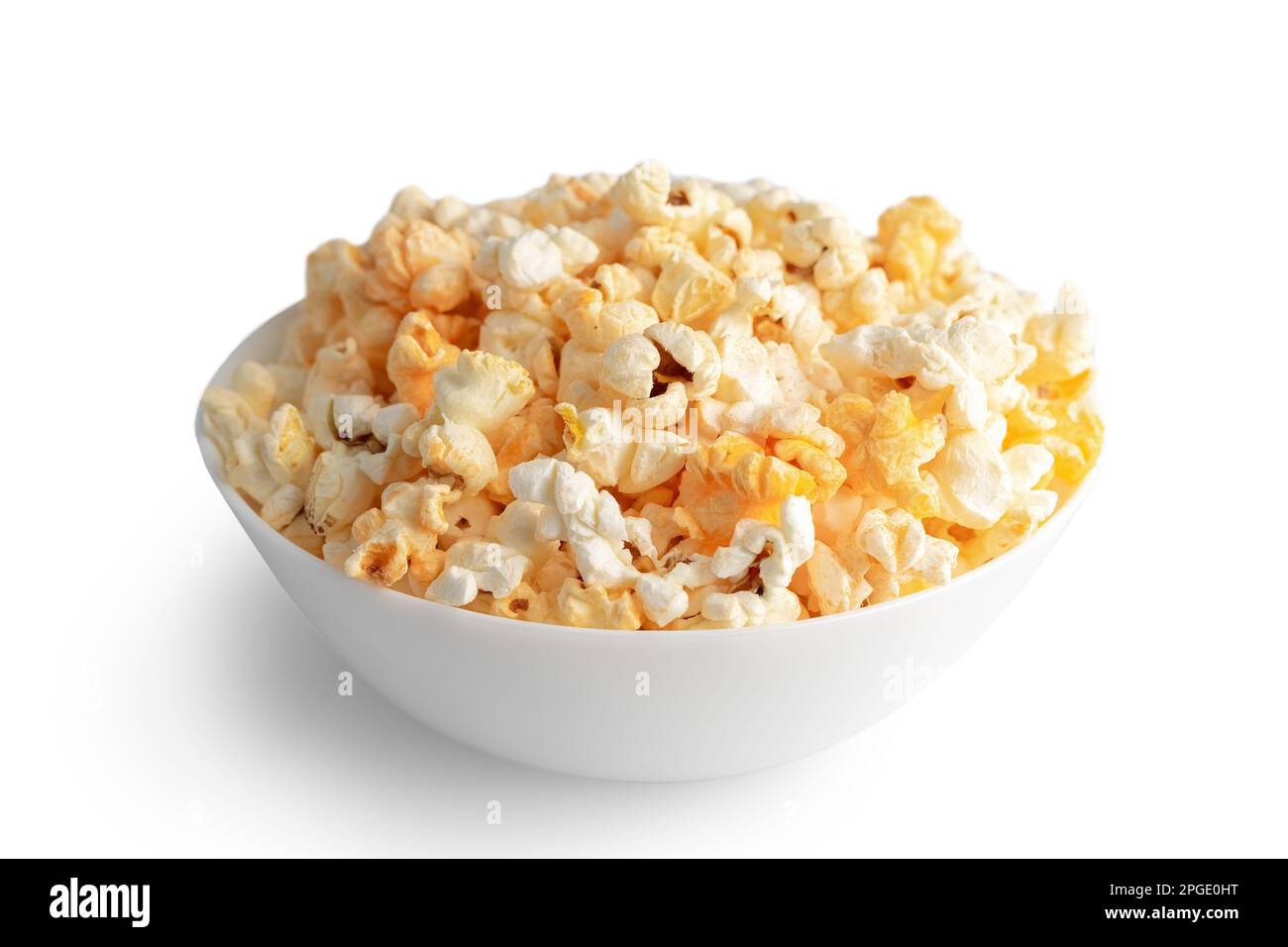 Tasty cheese popcorn in bowl isolated on white background close up. Movies, cinema and entertainment concept. Stock Photo