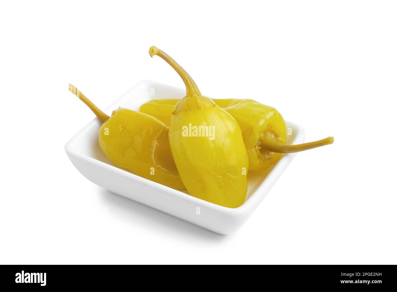Three pickled yellow peppers, pepperoncini or friggitelli isolated on
