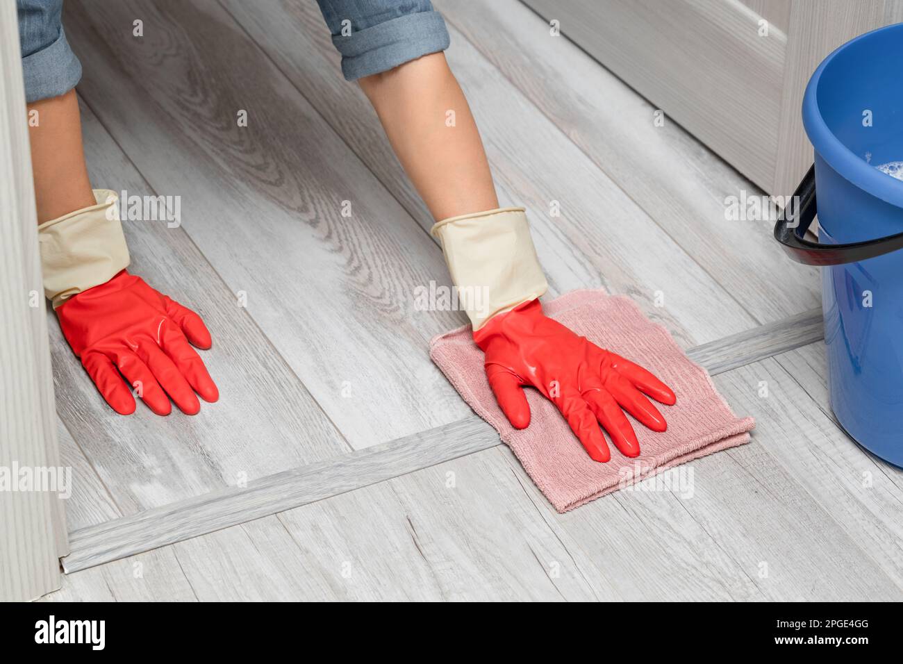 man wipes the door sill while cleaning the house. wet room cleaning