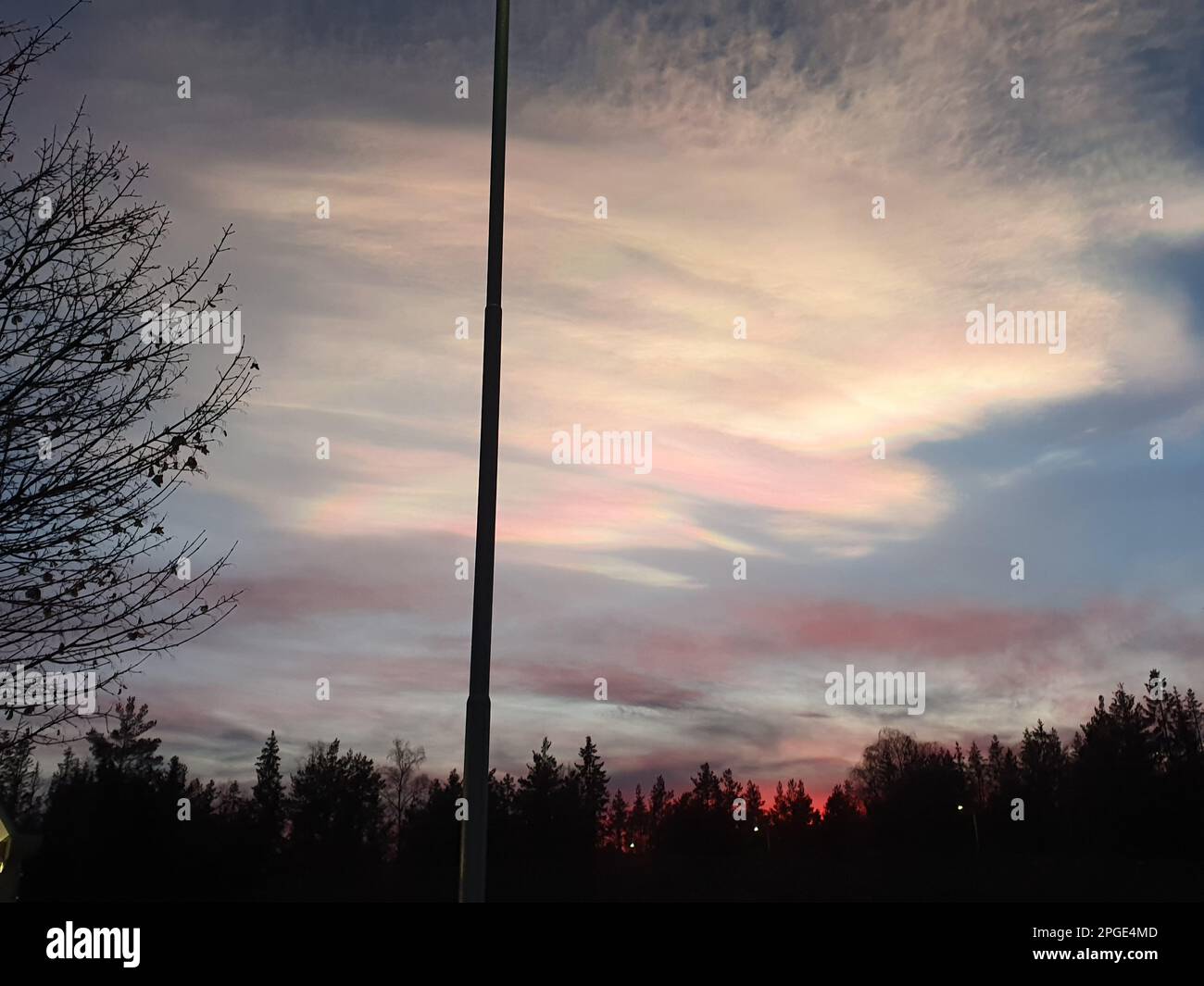 A street light illuminated in the foreground against a backdrop of an