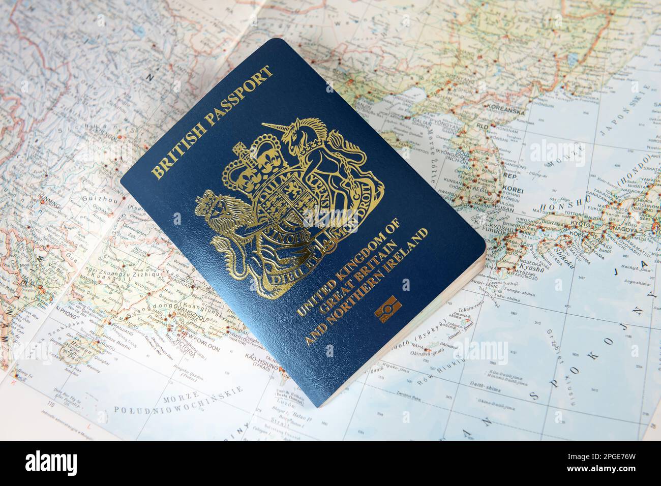 British UK passport laying on world map. Part of Japan and China map. Travel concept. Visa