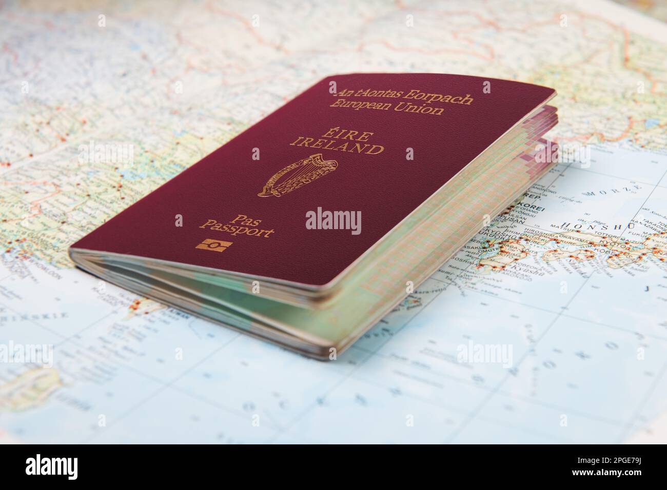 Irish European Union passport laying on world map. Part of Japan and China map. Travel concept