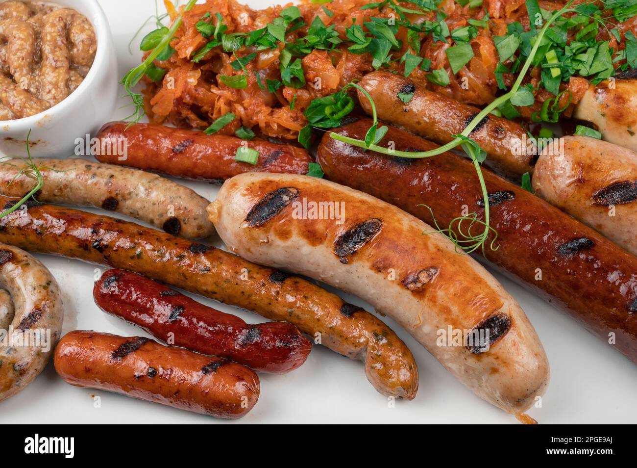Grilled different sausage with the addition of herbs and horseradish