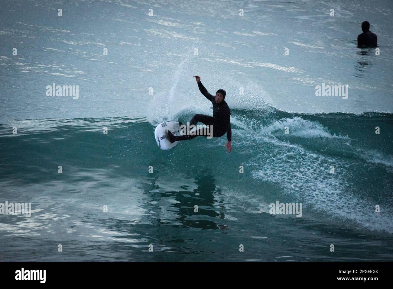 Cornish surfer photographed at Praa sands, Cornwall. Stock Photo