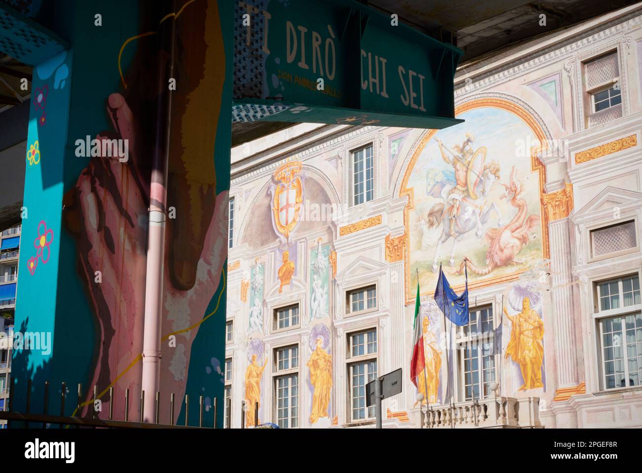 Graffiti on flyover support in front of decorative facade of Palazzo San Giorgio, Genoa, Liguria, Italy Stock Photo
