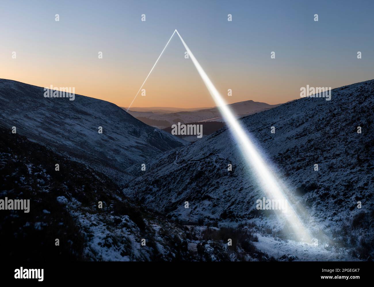 A beam of light through a winter landscape at dusk, a strange light source projects onto the natural landscape like energy Stock Photo